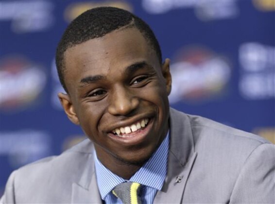 FILE - In this June 27, 2014, file photo, Cleveland Cavaliers draft pick Andrew Wiggins smiles during an NBA basketball conference in Independence, Ohio. Two people with knowledge of the deal tell The Associated Press that Minnesota and Cleveland have agreed to a trade that will send All-Star forward Kevin Love to the Cavaliers for Wiggins, Anthony Bennett and a future first-round draft pick. The two people spoke Thursday, Aug. 7, 2014, on condition of anonymity because no official agreement can be reached until Aug. 23, when Wiggins, this year's No. 1 draft pick, becomes eligible to be traded. (AP Photo/Tony Dejak, File)