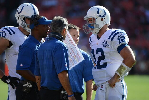 September 22, 2013; San Francisco, CA, USA; Indianapolis Colts offensive coordinator Pep Hamilton (visor) talks to quarterback Andrew Luck (12) during the fourth quarter against the San Francisco 49ers at Candlestick Park. The Colts defeated the 49ers 27-7. Mandatory Credit: Kyle Terada-USA TODAY Sports