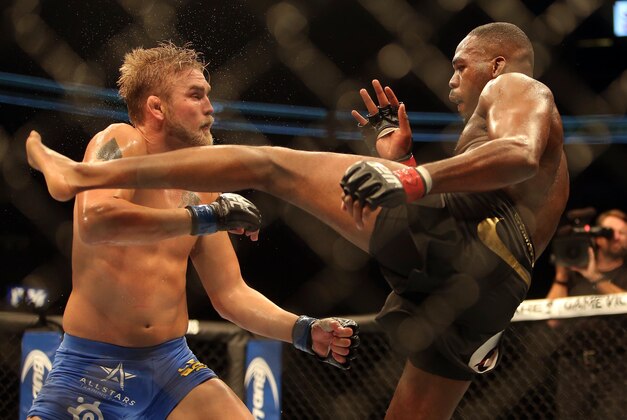 Sep 21, 2013; Toronto, Ontario, CAN; Jon Jones connects on a kick against Alexander Gustafsson (left) during their Light Heavyweight Championship bout at UFC 165 at the Air Canada Centre. Mandatory Credit: Tom Szczerbowski-USA TODAY Sports
