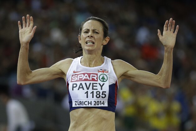 Britain's Jo Pavey crosses the line to win the gold medal in the women's 10,000m final during the European Athletics Championships in Zurich, Switzerland, Tuesday, Aug. 12, 2014. (AP Photo/Matt Dunham)