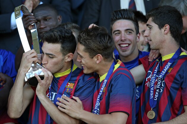 NYON, SWITZERLAND - APRIL 14: Munir El Haddadi of FC Barcelona (L) kisses the Lennart Johansson trophy after winning the UEFA Youth League Final match between Benfica Lisbon and FC Barcelona at Colovray Stadion on April 14, 2014 in Nyon, Switzerland. (Photo by Philipp Schmidli/Getty Images)