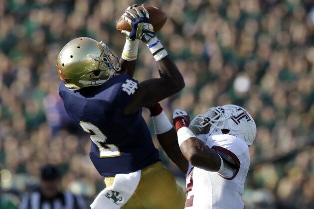 Notre Dame wide receiver Chris Brown (2) makes a catch over Temple defensive back Anthony Robey, right, for a 33-yard gain during the second half of an NCAA college football game in South Bend, Ind., Saturday, Aug. 31, 2013.  Notre Dame defeated Temple 28-6. (AP Photo/Michael Conroy)