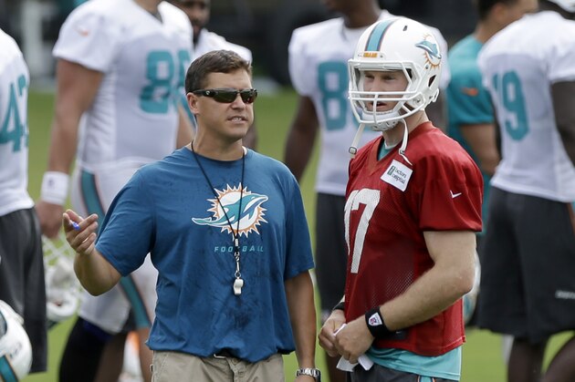 Miami Dolphins assistant coach Bill Lazor, left, talks to quarterback Ryan Tannehill during NFL football training camp Saturday, July 26, 2014, in Davie, Fla. (AP Photo/Alan Diaz)