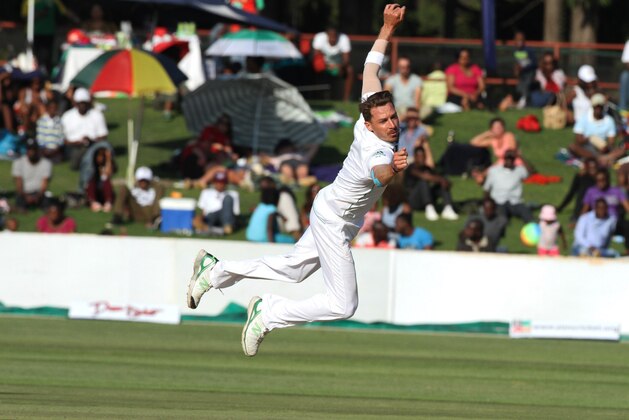 South African bowler Dale Steyn dives for the ball during the  Test match against Zimbabwe at Harare Sports club, Saturday, Aug. 9, 2014. Zimbabwe won the toss and elected to bat on the first day of the one off test against South Africa in Harare. (AP Photo/Tsvangirayi Mukwazhi)