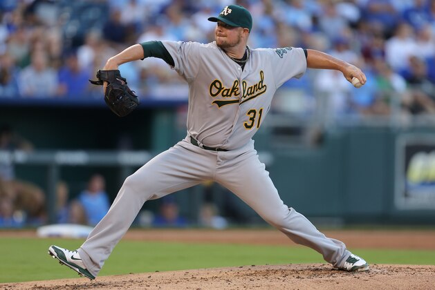 KANSAS CITY, MO - AUGUST 12:  Jon Lester #31 of the Oakland Athletics throws in the first inning against the Kansas City Royals at Kauffman Stadium on August 12, 2014 in Kansas City, Missouri. (Photo by Ed Zurga/Getty Images)