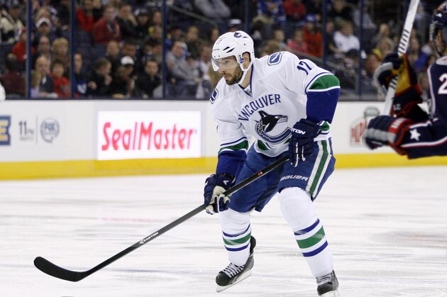Vancouver's Ryan Kesler moves the puck against Columbus during the first period of an NHL hockey game Sunday, Oct. 20, 2013, in Columbus, Ohio. (AP Photo/ Mike Munden)