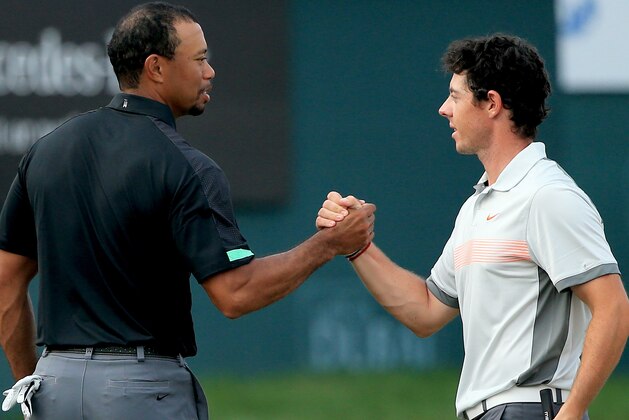 DUBAI, UNITED ARAB EMIRATES - JANUARY 31:  Rory McIlroy of Northern Ireland and Tiger Woods of the USA shake hands on the 18th greenduring the second round of the 2014 Omega Dubai Desert Classic on the Majlis Course at the Emirates Golf Club on January 31, 2014 in Dubai, United Arab Emirates. .  (Photo by Francois Nel/Getty Images)