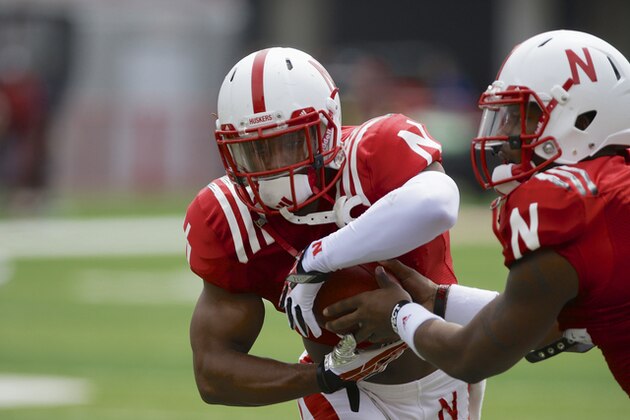 Nebraska quarterback Tommy Armstrong Jr., right, hands off the ball to running back Ameer Abdullah (8) during drills before the Nebraska NCAA college football spring game in Lincoln, Neb., Saturday, April 12, 2014. (AP Photo/Nati Harnik)