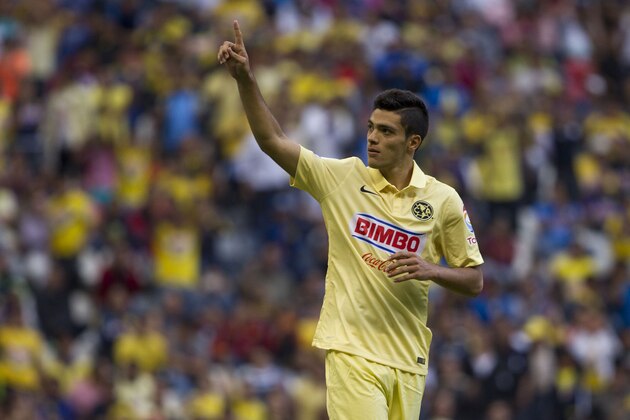 America's Raul Jimenez, celebrates after scoring against Atletico de Madrid during a friendly soccer match in Mexico City, Wednesday, July 30, 2014. (AP Photo/Christian Palma)