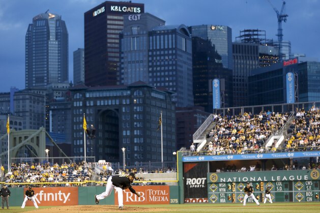 The city skyline is seen behind PNC Park as Pittsburgh Pirates starting pitcher Edinson Volquez, center, throws against the Detroit Tigers in the fourth inning of the baseball game on Tuesday, Aug. 12, 2014, in Pittsburgh. (AP Photo/Keith Srakocic)