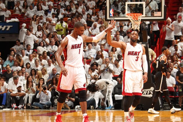 MIAMI, FL - MAY 6: Chris Bosh #1 and Dwyane Wade #3 of the Miami Heat celebrates in Game One of the Eastern Conference Semi-Finals against the Brooklyn Nets during the 2014 NBA Playoffs at American Airlines Arena on May 6, 2014 in Miami, Florida. NOTE TO USER: User expressly acknowledges and agrees that, by downloading and/or using this Photograph, user is consenting to the terms and conditions of the Getty Images License Agreement. Mandatory Copyright Notice: Copyright 2014 NBAE (Photo by Issac Baldizon/NBAE via Getty Images)