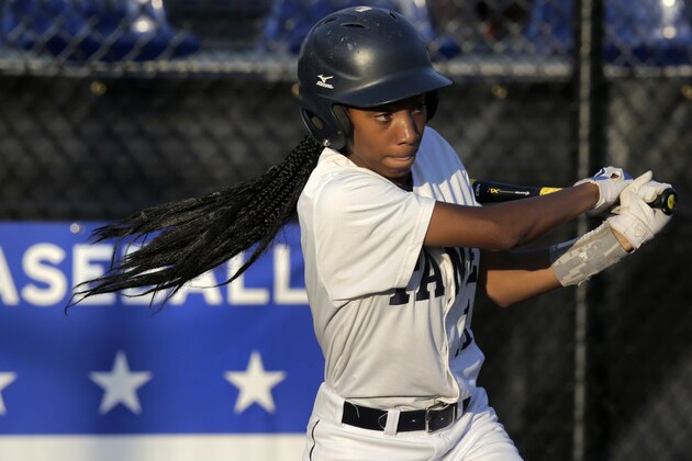 In this Aug. 6, 2014 photo, Pennsylvania's Mo'Ne Davis follows through on a single against the District of Columbia during a baseball game in the Little League Eastern Regionals at Breen Stadium in Bristol, Conn. Davis and New Jersey's Kayla Roncin are competing to make it to the Little League World Series, a rare feat for girls.  (AP Photo/Charles Krupa)