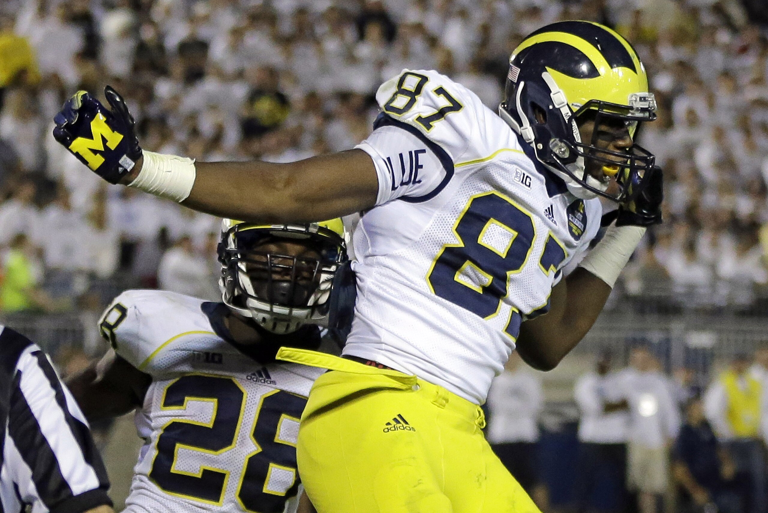 Michigan tight end Devin Funchess (87) celebrates with teammate Fitzgerald Toussaint (28) after his touchdown catch from Michigan quarterback Devin Gardner (98) late in the fourth quarter of an NCAA college football game against Penn State in State College, Pa., Saturday, Oct. 12, 2013. Penn State won 43-40 in the fourth overtime. (AP Photo/Gene J. Puskar) Michigan tight end Devin Funchess (87) celebrates with teammate Fitzgerald Toussaint (28) after his touchdown catch from Michigan quarterback Devin Gardner (98) late in the fourth quarter of an NCAA college football game against Penn State in State College, Pa., Saturday, Oct. 12, 2013. Penn State won 43-40 in the fourth overtime. (AP Photo/Gene J. Puskar)