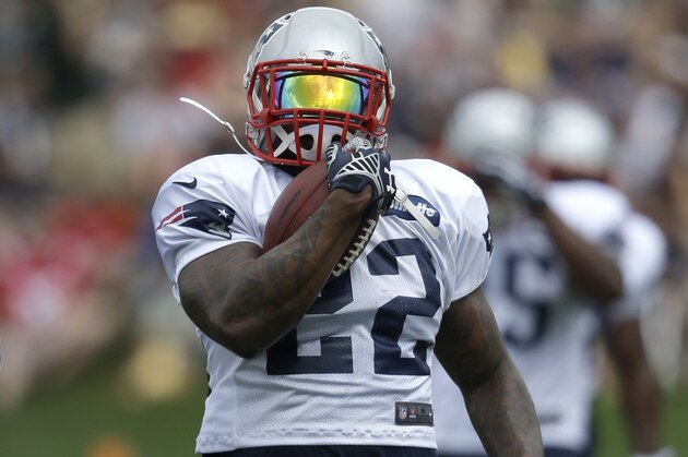 New England Patriots running back Stevan Ridley runs with the ball during an NFL football training camp practice at Gillette Stadium, Sunday, July 27, 2014, in Foxborough, Mass. (AP Photo/Steven Senne)