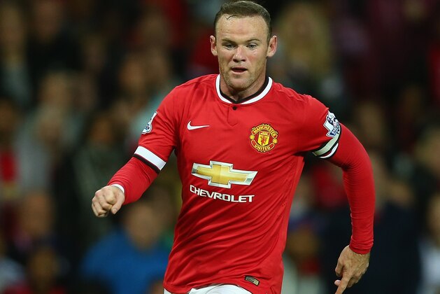MANCHESTER, ENGLAND - AUGUST 12:  Wayne Rooney of Manchester United in action during the Pre Season Friendly match between Manchester United and Valencia at Old Trafford on August 12, 2014 in Manchester, England.  (Photo by Clive Brunskill/Getty Images)