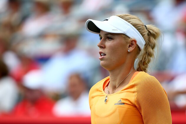 MONTREAL, QC - AUGUST 08:  Caroline Wozniacki of Denmark watches on against Serena Williams of the USA in their quarterfinal match during the Rogers Cup at Uniprix Stadium on August 8, 2014 in Montreal, Canada.  (Photo by Streeter Lecka/Getty Images)