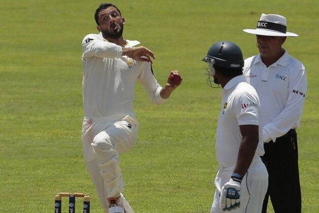 Pakistani bowler Junaid Khan delivers a ball as Sri Lankan batsman Kumar Sangakkara watches during the first day of the second test cricket match between Sri Lanka and Pakistan in Colombo, Sri Lanka, Thursday, Aug. 14, 2014. (AP Photo/Eranga Jayawardena)