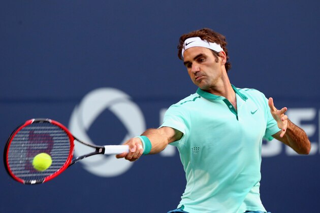 TORONTO, ON - AUGUST 05:  Roger Federer of Switzerland returns a shot to Peter Polansky of Canada during Rogers Cup at Rexall Centre at York University on August 5, 2014 in Toronto, Canada.  (Photo by Ronald Martinez/Getty Images)