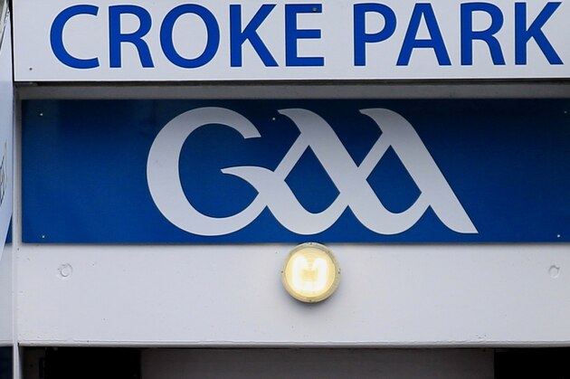 Britain's Queen Elizabeth II, centre, Irish President Mary Mc Aleese, left and  Christy Cooney, President of the Gaelic Athletic Association look out at the pitch at the home of the GAA, Croke Park Stadium, in Dublin, Wednesday May 18, 2011, site of a notorious massacre where British troops killed 14 Irish civilians in 1920.  The Queen's visit to Croke Park on the second day of her historic trip to the Republic of Ireland highlights the vast improvement in Anglo-Irish relations since those dark days. It brought the English monarch to a large sports stadium that is a revered spot for Irish nationalists who mourn those who died there during the conflict with Britain.(AP Photo/Peter Morrison)