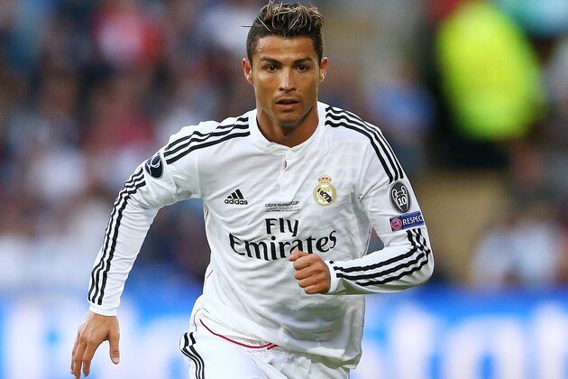 CARDIFF, WALES - AUGUST 12:  Cristiano Ronaldo of Real Madrid runs with the ball during the UEFA Super Cup between Real Madrid and Sevilla FC at Cardiff City Stadium on August 12, 2014 in Cardiff, Wales.  (Photo by Clive Mason/Getty Images)