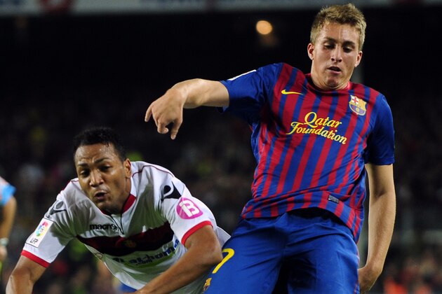 FC Barcelona's Gerard Deulofeu, right, duels for the ball against Mallorca's Emilio Nsuea during a Spanish La Liga soccer match at the Camp Nou stadium in Barcelona, Spain, Saturday, Oct. 29, 2011. (AP Photo/Manu Fernandez)