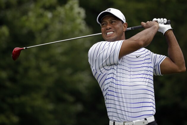 FILE - In this Friday, Aug. 8, 2014 file photo, Tiger Woods winces after tee shot on the sixth hole during the second round of the PGA Championship golf tournament at Valhalla Golf Club in Louisville, Ky. Tiger Woods removed himself from consideration for the Ryder Cup team Wednesday evening, Aug. 13, 2014 with a clear message that he is not healthy enough to play. (AP Photo/Jeff Roberson, File)