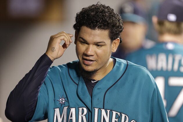 Seattle Mariners starting pitcher Felix Hernandez walks in the dugout during a baseball game against the Toronto Blue Jays, Monday, Aug. 11, 2014, in Seattle. (AP Photo/Ted S. Warren)