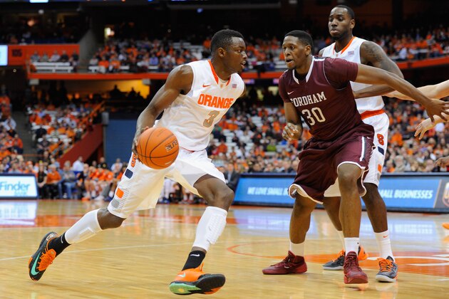 SYRACUSE, NY - NOVEMBER 12:  Jerami Grant #3 of the Syracuse Orange drives to the basket around Ryan Rhoomes #30 of the Fordham Rams during the first half at the Carrier Dome on November 12, 2013 in Syracuse, New York.  (Photo by Rich Barnes/Getty Images)