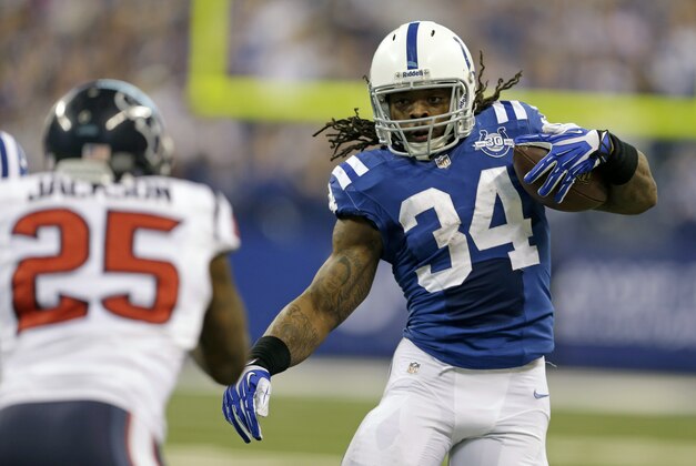 Indianapolis Colts running back Trent Richardson, right, tries to avoid the tackle of Houston Texans cornerback Kareem Jackson on his way to an 18-yard gain on a catch during the first half of an NFL football game in Indianapolis, Sunday, Dec. 15, 2013. (AP Photo/Darron Cummings)