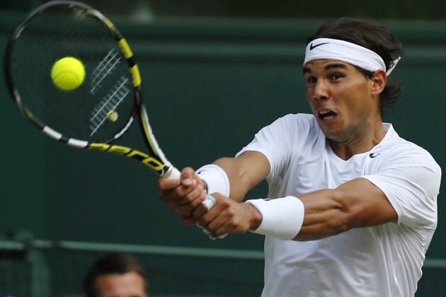 Rafael Nadal of Spain plays a return to Nick Kyrgios of Australia during their men's singles match at the All England Lawn Tennis Championships in Wimbledon, London, Tuesday, July 1, 2014. (AP Photo/Ben Curtis)