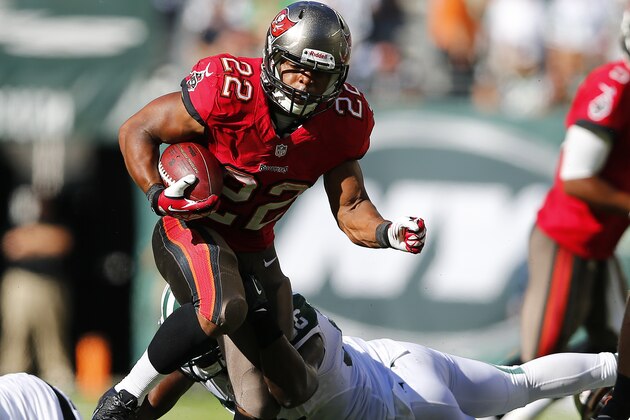 EAST RUTHERFORD, NJ - SEPTEMBER 8: Running back Doug Martin #22 of the Tampa Bay Buccaneers is breaks away from the traps of linebacker DeMario Davis #56 of the New York Jets in the fourth quarter during a game at MetLife Stadium on September 8, 2013 in East Rutherford, New Jersey. The Jets defeated the Bucs 18-17. (Photo by Rich Schultz /Getty Images)