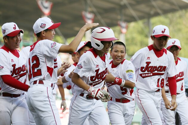 WILLIAMSPORT, PA - AUGUST 25:  Shunpei Takagi #7 of the Tokyo, Japan team (C) celebrates after hitting a solo home run against the West team from Chula Vista, Ca during the Little League World Series Championship game on August 25, 2013 in Williamsport, Pennsylvania.  (Photo by Rob Carr/Getty Images)