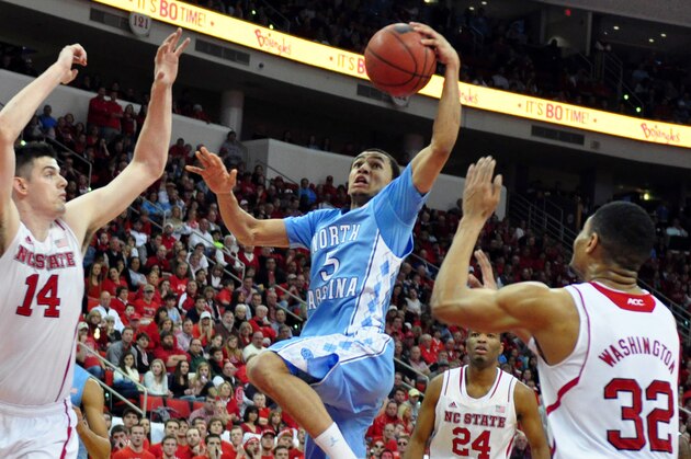 Feb 26, 2014; Raleigh, NC, USA; North Carolina Tar Heels guard Marcus Paige (5) lays the ball up ahead of North Carolina State Wolfpack center Jordan Vandenberg (14) and forward Kyle Washington (32) during the second half at PNC Arena. The Tar Heels won 85-84 in overtime. Mandatory Credit: Rob Kinnan-USA TODAY Sports Feb 26, 2014; Raleigh, NC, USA; North Carolina Tar Heels guard Marcus Paige (5) lays the ball up ahead of North Carolina State Wolfpack center Jordan Vandenberg (14) and forward Kyle Washington (32) during the second half at PNC Arena. The Tar Heels won 85-84 in overtime. Mandatory Credit: Rob Kinnan-USA TODAY Sports