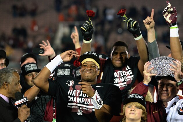 PASADENA, CA - JANUARY 06:  Florida State Seminoles head coach Jimbo Fisher (R) holds the Coaches' Trophy as quarterback Jameis Winston (center) #5 celebrates after defeating the Auburn Tigers 34-31 in the 2014 Vizio BCS National Championship Game at the Rose Bowl on January 6, 2014 in Pasadena, California.  (Photo by Harry How/Getty Images)
