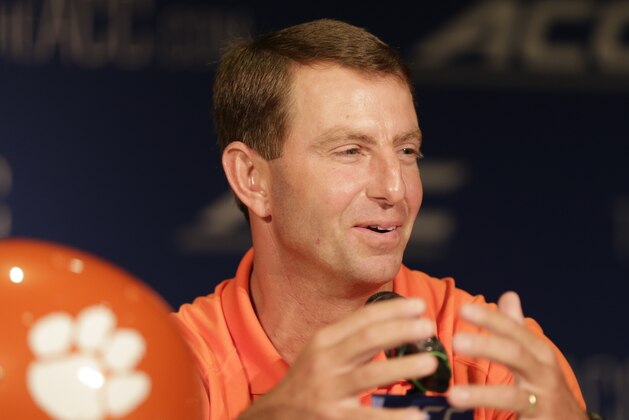 Clemson head coach Dabo Swinney answers a question during a news conference at the Atlantic Coast Conference Football kickoff in Greensboro, N.C., Monday, July 21, 2014. (AP Photo/Chuck Burton)