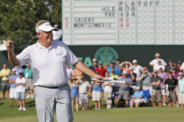 Colin Montgomerie celebrates after sinking a putt on the 18th green to win, during a three-hole aggregate playoff with Gene Sauers in the final round of the  U.S. Senior Open golf tournament at Oak Tree National in Edmond, Okla., Sunday, July 13, 2014. (AP Photo/Sue Ogrocki)
