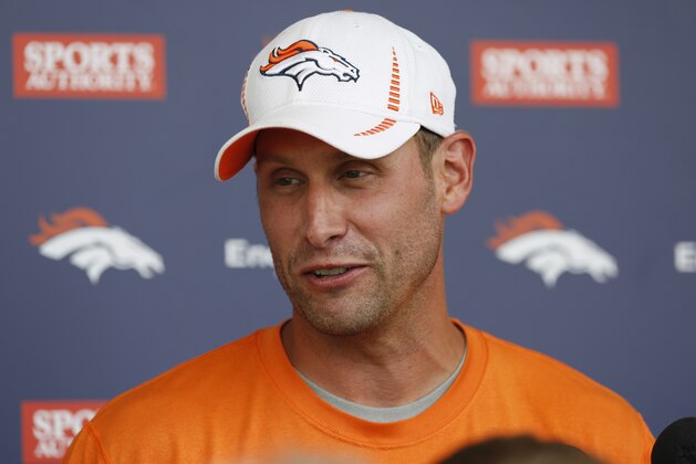 Denver Broncos offensive coordinator Adam Gase talks after the morning session at the team's NFL training camp at Broncos headquarters in Englewood, Colo., on Friday, Aug. 1, 2014. (AP Photo/David Zalubowski)
