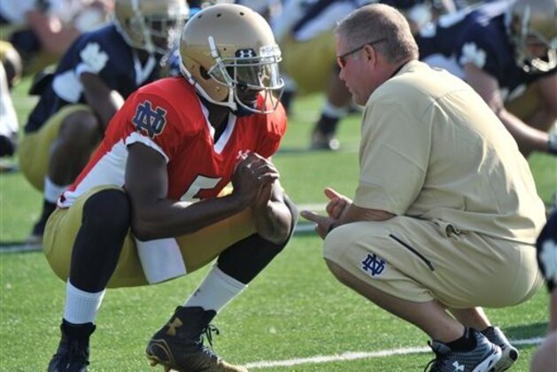 FILE - In this Aug. 9, 2014, file photo, Notre Dame coach Brian Kelly, right, talks with quarterback Everett Golson during practice in South Bend, Ind. Golson has reclaimed the job as Notre Dame's starting quarterback after being suspended last semester for academic impropriety. Coach Brian Kelly on Wednesday, Aug. 13, 2014, said Golson would start against Rice on Aug. 30 and said he hopes he will be the starter for the entire season.  (AP Photo/Joe Raymond, FILE)