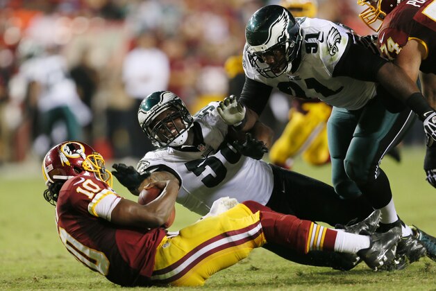 LANDOVER, MD - SEPTEMBER 09:  Quarterback Robert Griffin III #10 of the Washington Redskins is sacked by defensive tackle Fletcher Cox #91 and  Trent Cole #58 of the Philadelphia Eagles during the fourth quarter of the Eagles 33-27 win at FedExField on September 9, 2013 in Landover, Maryland.  (Photo by Rob Carr/Getty Images)