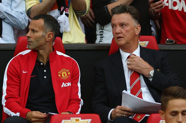 MANCHESTER, ENGLAND - AUGUST 12:  Manchester United manager Louis Van Gaal with his coach Ryan Giggs on the bench as he makes his home debut during the Pre Season Friendly match between Manchester United and Valencia at Old Trafford on August 12, 2014 in Manchester, England.  (Photo by Clive Brunskill/Getty Images)