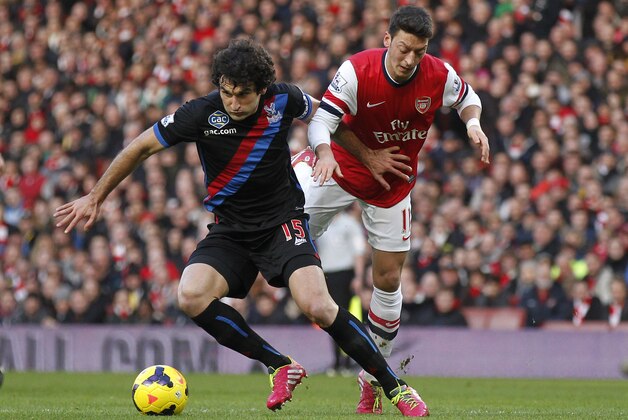 Arsenal's Mesut Ozil, right, competes with Crystal Palace's Mile Jedinak during their English Premier League soccer match at Emirates Stadium in London, Sunday, Feb. 2, 2014. (AP Photo/Sang Tan) Arsenal's Mesut Ozil, right, competes with Crystal Palace's Mile Jedinak during their English Premier League soccer match at Emirates Stadium in London, Sunday, Feb. 2, 2014. (AP Photo/Sang Tan)