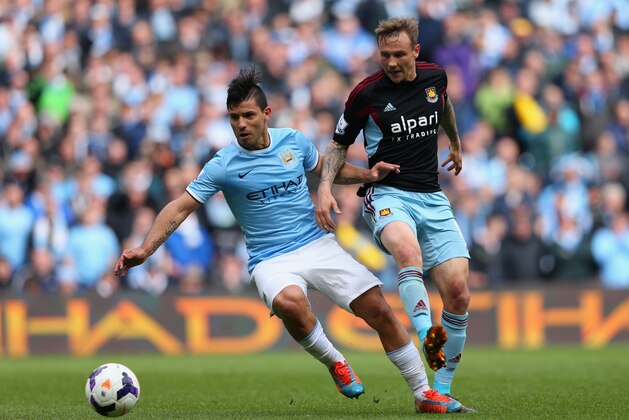 MANCHESTER, ENGLAND - MAY 11:  Sergio Aguero of Manchester City competes with Matt Taylor of West Ham during the Barclays Premier League match between Manchester City and West Ham United at the Etihad Stadium on May 11, 2014 in Manchester, England.  (Photo by Alex Livesey/Getty Images)