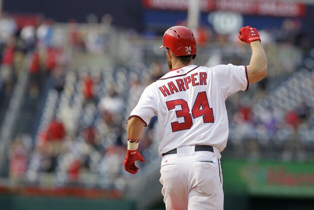 Washington Nationals’ Bryce Harper celebrates his two-run home run as he approaches second base during the 13th inning of a baseball game against the New York Mets, Thursday, Aug. 7, 2014, in Washington. The Nationals won 5-3 in 13 innings. (AP Photo/Luis M. Alvarez)