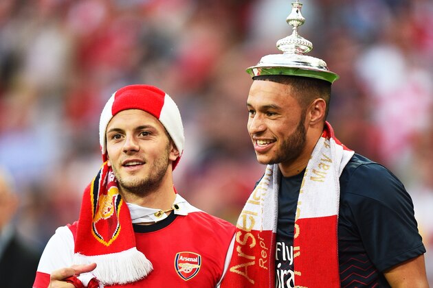 LONDON, ENGLAND - MAY 17:  Jack Wilshere (L) and Alex Oxlade-Chamberlain of Arsenal celebrate victory with the trophy  after the FA Cup with Budweiser Final match between Arsenal and Hull City at Wembley Stadium on May 17, 2014 in London, England.  (Photo by Shaun Botterill/Getty Images)