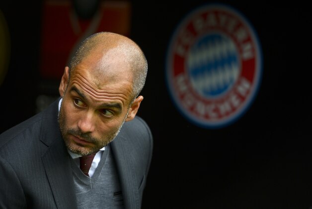 Munich's coach Pep Guardiola watches during the German soccer Super Cup match between Borussia Dortmund and Bayern Munich in Dortmund, Germany, Wednesday, Aug. 13, 2014. (AP Photo/Sascha Schuermann)