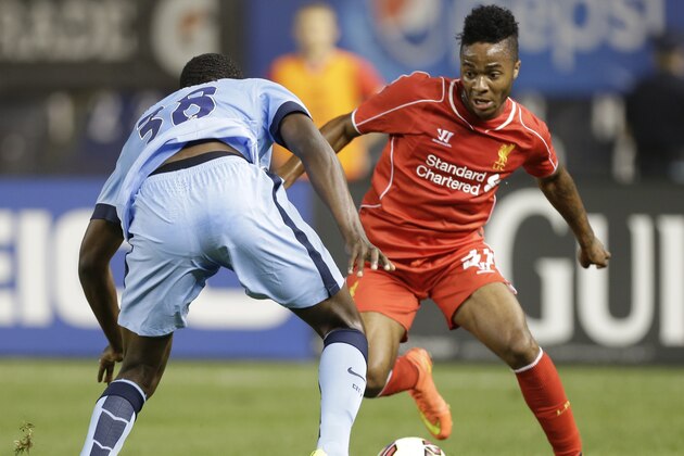 Liverpool's Raheem Sterling (31) is defended by Manchester City's Dedryck Boyata (38) in the second half of a Guinness International Champions Cup soccer tournament match  Wednesday, July 30, 2014, in New York. Liverpool won the game 3-2 in a penalty kick shootout. (AP Photo/Frank Franklin II)