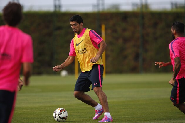 Luis Suarez, of Uruguay, trains during a training session at the Sports Center FC Barcelona Joan Gamper in San Joan Despi, in Barcelona, Spain, Friday, Aug. 15, 2014. Suarez trained with his Barcelona teammates on Friday after his ban for biting an opponent at the World Cup was softened but not shortened. The Court of Arbitration for Sport ruled Thursday that the Uruguay forward, who recently left Liverpool for Barcelona, deserves his four-month ban from playing official matches for both his club and his country. (AP Photo/Emilio Morenatti ) Luis Suarez, of Uruguay, trains during a training session at the Sports Center FC Barcelona Joan Gamper in San Joan Despi, in Barcelona, Spain, Friday, Aug. 15, 2014. Suarez trained with his Barcelona teammates on Friday after his ban for biting an opponent at the World Cup was softened but not shortened. The Court of Arbitration for Sport ruled Thursday that the Uruguay forward, who recently left Liverpool for Barcelona, deserves his four-month ban from playing official matches for both his club and his country. (AP Photo/Emilio Morenatti )