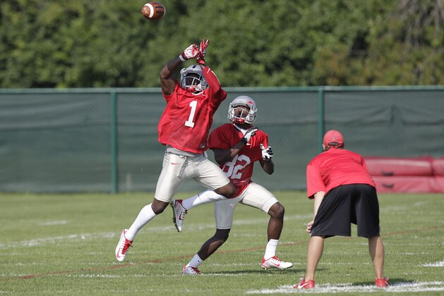 Ohio State wide receiver Johnnie Dixon, left, tries to catch a pass in front of wide receiver James Clark during an NCAA college football practice Saturday, Aug. 9, 2014, in Columbus, Ohio. (AP Photo/Jay LaPrete)