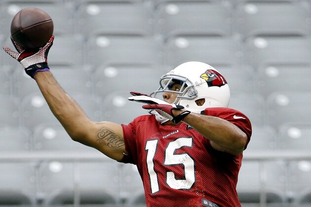 Arizona Cardinals receiver Michael Floyd makes a catch during an NFL football training camp, Tuesday, July 29, 2014, in Glendale, Ariz. (AP Photo/Matt York)
