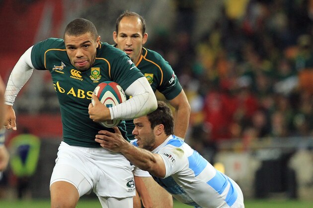 South Africa's Bryan Habana, left, is challenged by Argentina's Martin Landajo, right, as his teammate Fourie du Preez, back, looks on during their Rugby Test match at Soccer City Stadium in Johannesburg, South Africa, Saturday, Aug. 17, 2013. (AP Photo/Themba Hadebe)
